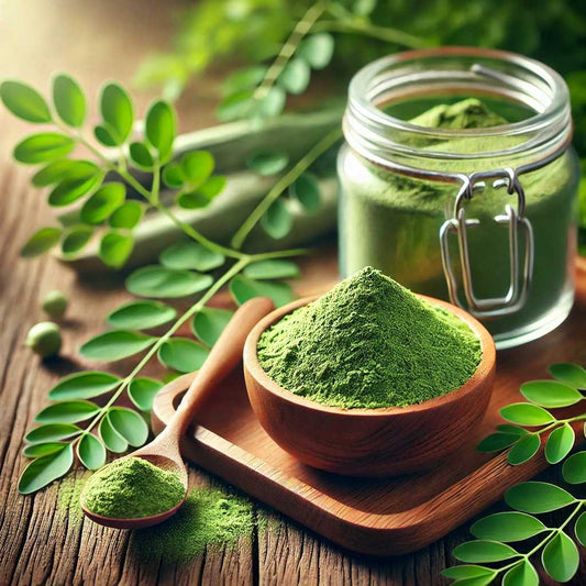 showcasing a glass jar of green moringa powder placed on a wooden table, with a spoonful of powder beside it, Vital cave organics