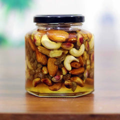 Glass jar filled with a mix of nuts on a wooden surface Vitalcave organics