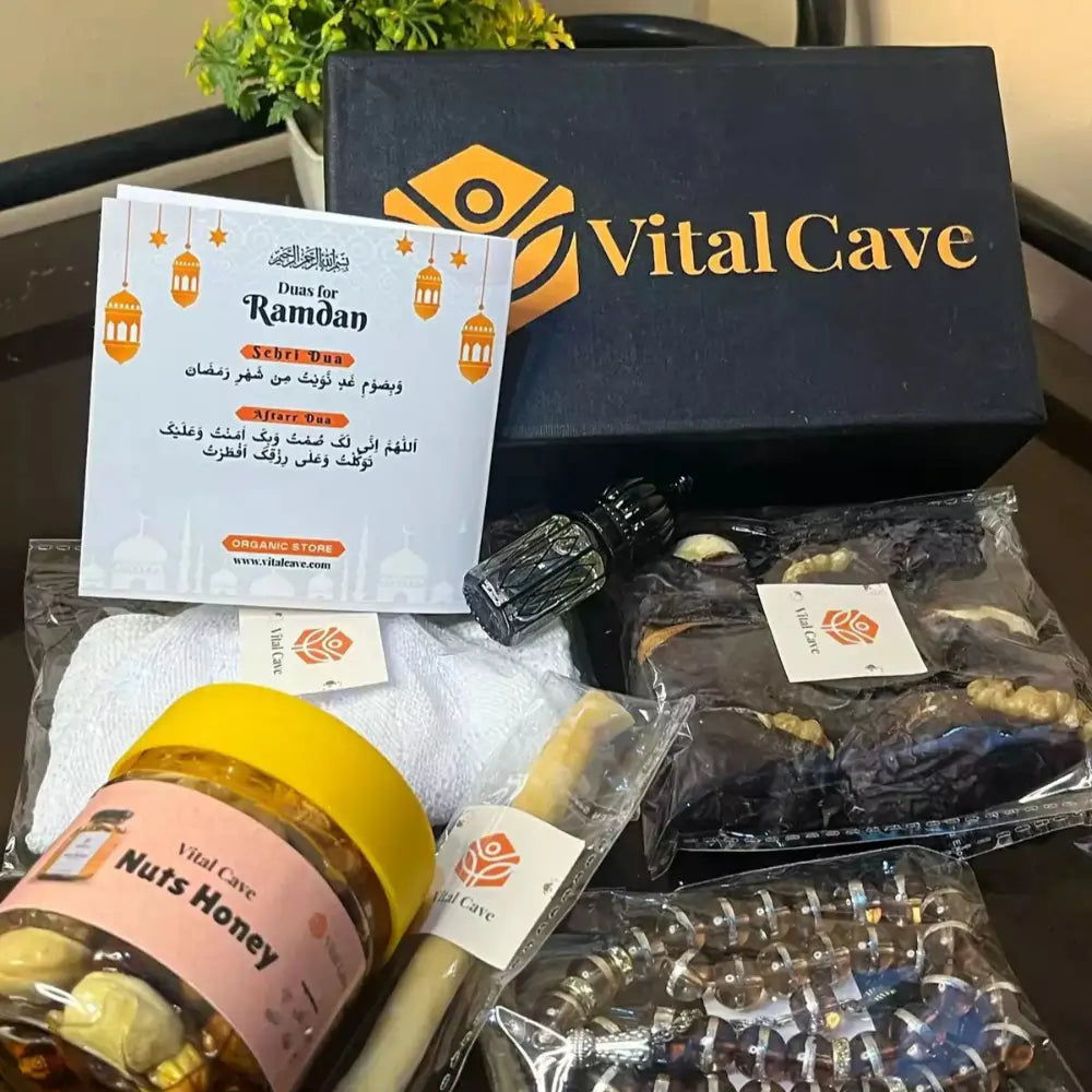Vital Cave product set with honey, tools, and packaging on a table-Vital cave Gift box in Nuts, honey, tabseeh, miswak nuts, date Ramzan card, ittar